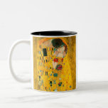 Gustav Klimt The Kiss Two-Tone Coffee Mug<br><div class="desc">Coffee Mug featuring Gustav Klimt’s oil painting with gold leaf The Kiss (1908). A man and woman,  wearing brilliant golden colors,  lovingly embrace and kiss in a field of flowers. A great gift for fans of Art Nouveau and Austrian art.</div>