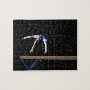Gymnast (9-10) flipping on balance beam, side jigsaw puzzle