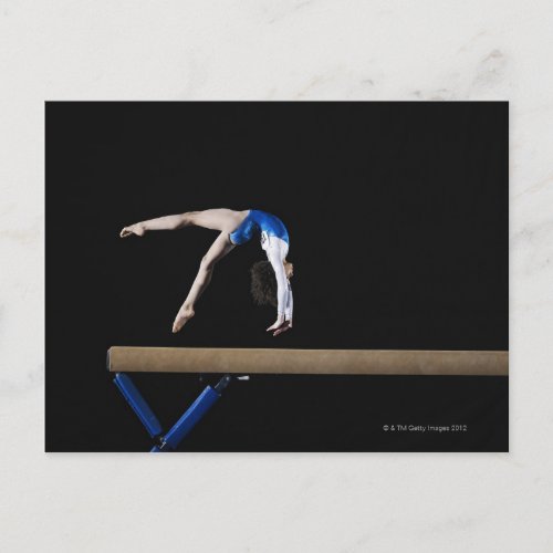 Gymnast 9_10 flipping on balance beam side postcard