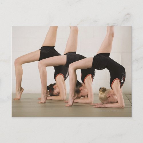 Gymnasts posing upside down postcard