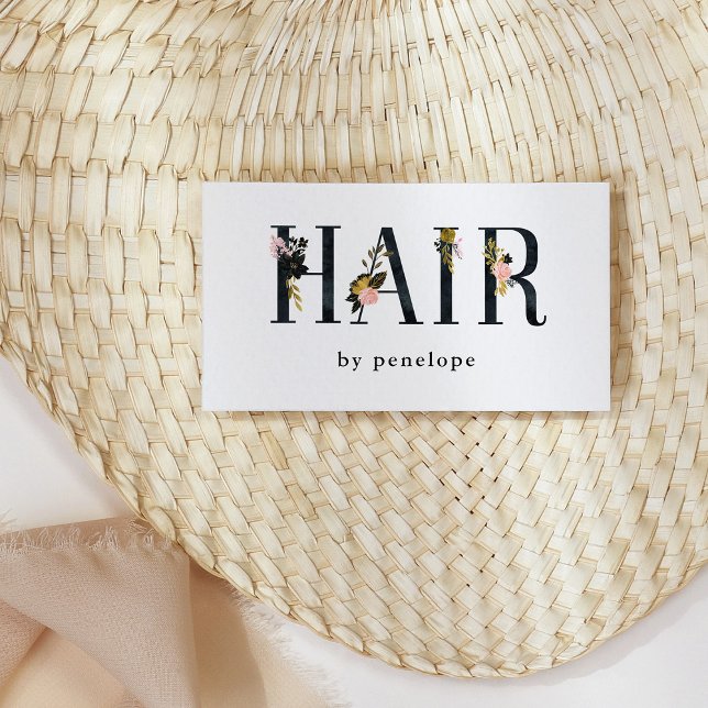 Hairstylist | Gold Blush Black Floral Typography Business Card (Pretty business cards for hairstylists with black letters and floral typography)