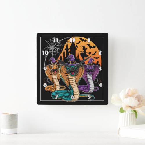 Halloween snakes in vibrant costumes at night square wall clock