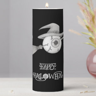 Halloween witch broom and scary eyeball pillar candle