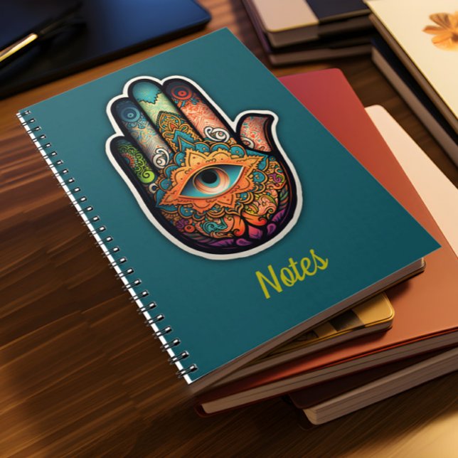 Hamsa Hand Spiral Notebook (A pile of notebooks lies on a desk)