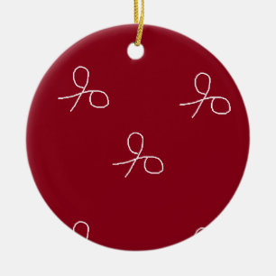 Hand drawn scissors on maroon red ceramic ornament