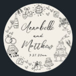 Hand Drawn Vintage Whimsical Wedding Classic Round Sticker<br><div class="desc">Personalized Hand-Drawn Quirky Wedding Stickers. These fun and playful round wedding stickers feature quirky doodle illustrations surrounding the edges, all in bold black against a soft off-white ivory background, giving them a rustic, vintage, or gently aged look. Elements like a champagne tower, wedding cake, disco ball, hearts, wedding bells, rings,...</div>