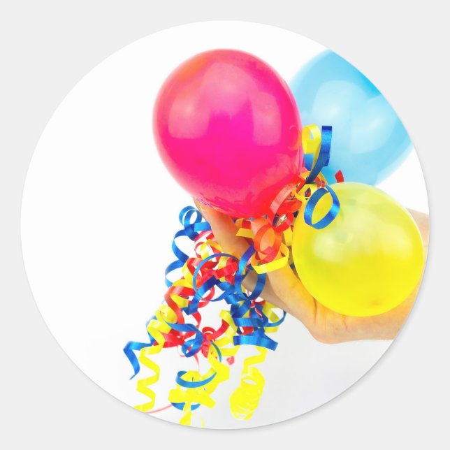Hand giving colorful balloons with ribbons classic round sticker (Front)