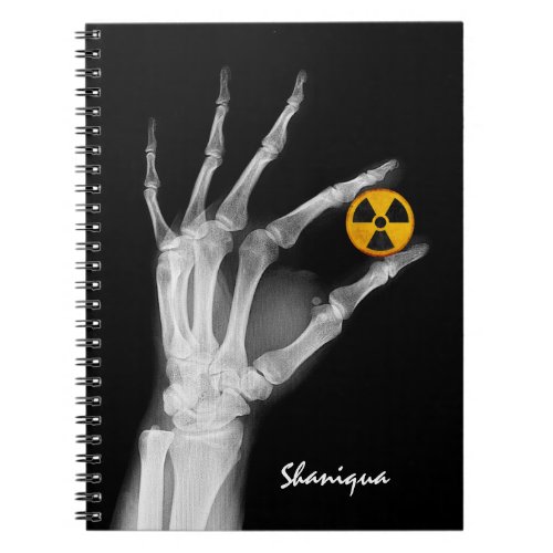 Hand Holding a Radiation Symbol   Notebook