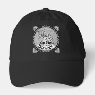 Hand holding caduceus doctor hat