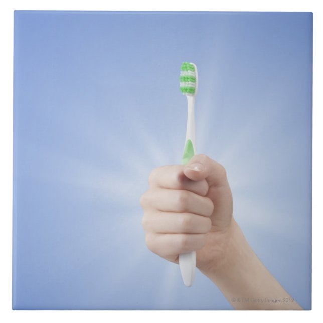 Hand holding tooth brush ceramic tile (Front)