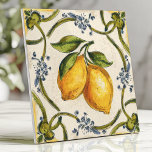 Hand-Painted Sicilian Lemons and Floral Vine Ceramic Tile<br><div class="desc">Bring a taste of the Mediterranean to your home with this hand-painted design featuring vibrant Sicilian lemons, intertwining green vines, and delicate blue floral accents. The warm yellow and green tones, paired with a rustic, slightly textured background, create an elegant and timeless aesthetic. Perfect for backsplashes, accent walls, or adding...</div>