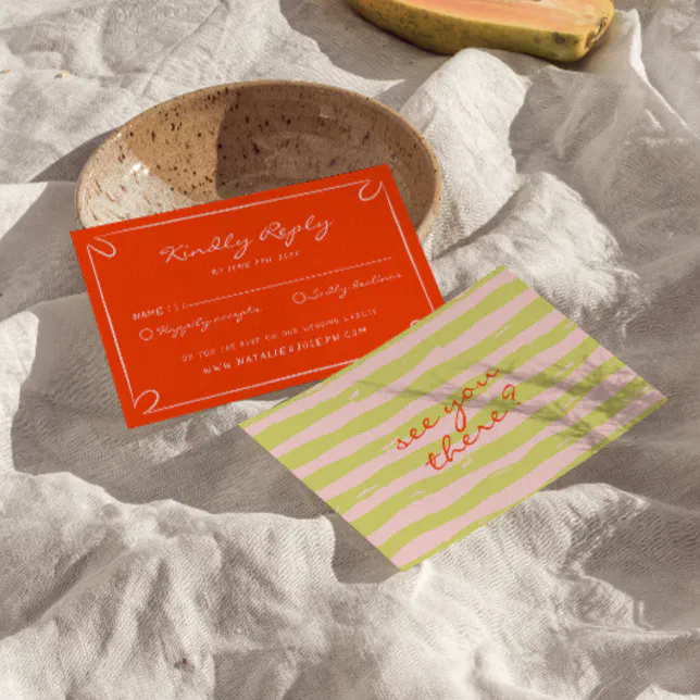 An Italian-themed RSVP card featuring a script font and a pinstripe motif. The card is lying on a bowl.