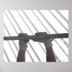 Hands of a male gymnast gripping a horizontal poster