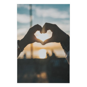 Hands shaped like a heart in the sunset faux canvas print