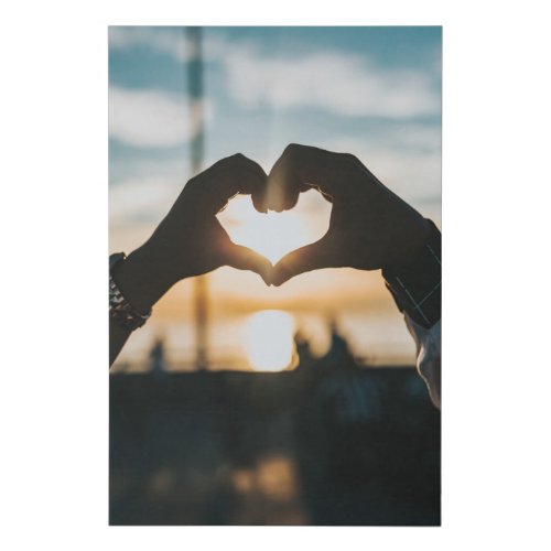 Hands shaped like a heart in the sunset faux canvas print