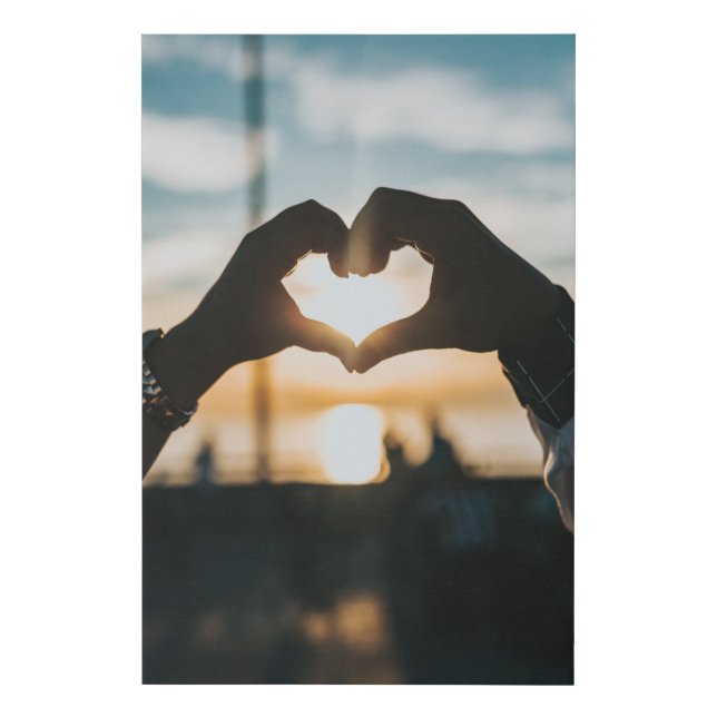 Hands shaped like a heart in the sunset faux canvas print (Front)