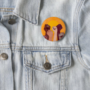 Hands with fist raised up over yellow sun button