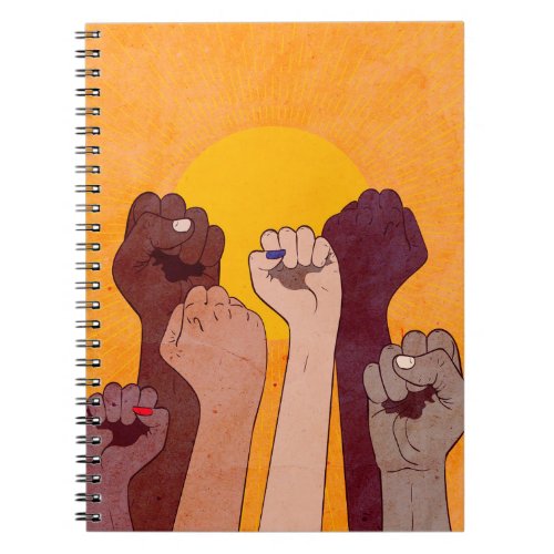 Hands with fist raised up over yellow sun notebook