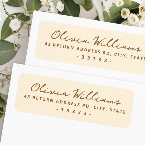 Handwritten script cream colored return address label