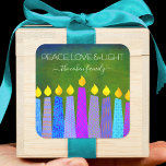 Hanukkah Blue Boho Candles Green Peace Love Light Square Sticker<br><div class="desc">“Peace, love & light.” A playful, modern, artsy illustration of boho pattern candles helps you usher in the holiday of Hanukkah. Assorted blue candles with colorful faux foil patterns overlay a rich, deep green textured background. Feel the warmth and joy of the holiday season whenever you use this stunning, colorful,...</div>