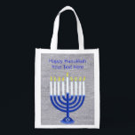 Hanukkah Dark Blue Menorah Silver Minimalist Reusable Grocery Bag<br><div class="desc">This festive Happy Hanukkah reusable tote can be used as a jumbo gift bag for an extra large present or take it to the mall. The navy blue and white Menorah with a Star Of David design on the base is showcased on a background of faux silver cloth. Click on...</div>