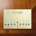 Hanukkah Gold Menorah and Candles "Love and Light" Holiday Card<br><div class="desc">Send warm wishes and celebrate the joyous festival of Hanukkah with our exquisite greeting card featuring a vibrant gold menorah. The work captures the essence of the festival,  symbolizing the triumph of light over darkness.</div>