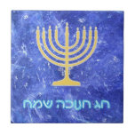 Hanukkah Snowstorm Menorah Ceramic Tile<br><div class="desc">A glowing gold Hanukkah menorah and  "Chag Chanukkah Sameach" (Happy Hanukkah) in glowing blue and white text superimposed on a blue and white fractal image reminiscent of snowflakes in a storm.</div>