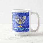 Hanukkah Snowstorm Menorah Coffee Mug<br><div class="desc">A glowing gold Hanukkah menorah and Hebrew text reading "Chag Chanukkah Sameach" (Happy Hanukkah) in glowing blue and white text superimposed on a blue and white fractal image reminiscent of snowflakes in a storm. Add your own additional text.</div>