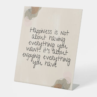 Happiness is not about having everything you want. pedestal sign