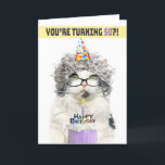 Happy Birthday 50th Funny Old Lady Cat in Hat Holiday Card<br><div class="desc">Gazing over the rims of her reading glasses,  this delightful cat sports a festive party hat,  presenting a birthday cake with whimsical charm. It’s the purr-fect way to send joyful birthday wishes to someone celebrating the big five-oh</div>