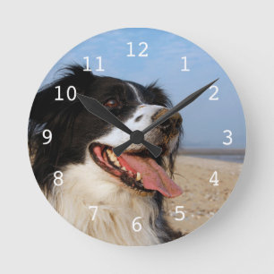Happy dog at the beach round clock