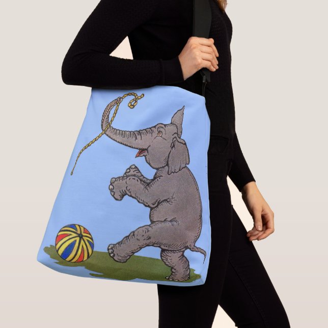 happy elephant playing with rope and ball crossbody bag (Close Up)
