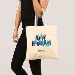 Happy Hanukkah Candles Holiday  Tote Bag<br><div class="desc">Make your Chanukah shopping and errands a little more festive with this tote bag, or use as a gift or favor. The greeting "Happy Hanukkah" is spelled out in blue tonal colors. The stacked letters serve as a menorah with small flames burning on top of nine "candle letters". Add your...</div>
