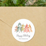 Happy Holidays Pine Tree Watercolor Christmas Classic Round Sticker<br><div class="desc">Simple and elegant stickers for your Christmas gifts and correspondence featuring a watercolor abstract of pine trees in muted sage green,  red,  gold and orange,  "Happy Holidays" in a stylish script and your name in modern typography.</div>