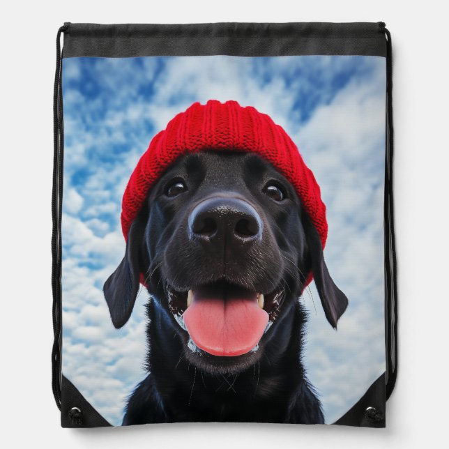 Happy Labrador in a Red Beanie Under a Blue Sky Drawstring Bag (Front)
