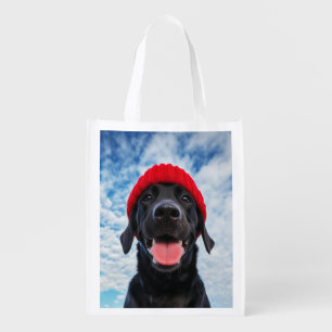 Happy Labrador in a Red Beanie Under a Blue Sky Grocery Bag