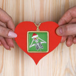 Happy Skeleton Ornament Fur Trimmed Hat Green Gold Gold Plated Necklace<br><div class="desc">This pendant type necklace has a happy Christmas skeleton holding two ornaments up to his eyes wearing a red fur trimmed Santa hat on a green background with tiny gold specks.</div>