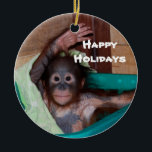 Happy Smiling Animal Baby Holiday Ceramic Ornament<br><div class="desc">Here's a holiday ornament that helps to save orphaned wildlife. The orangutan baby on this ornament is one of hundreds of orphans on the island of Borneo. The artist donates 100% of all profits from the sale of this item to support the Care Center where these babies are cared for...</div>