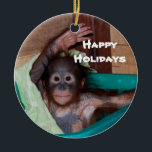 Happy Smiling Animal Baby Holiday Ceramic Ornament<br><div class="desc">Here's a holiday ornament that helps to save orphaned wildlife. The orangutan baby on this ornament is one of hundreds of orphans on the island of Borneo. The artist donates 100% of all profits from the sale of this item to support the Care Center where these babies are cared for...</div>