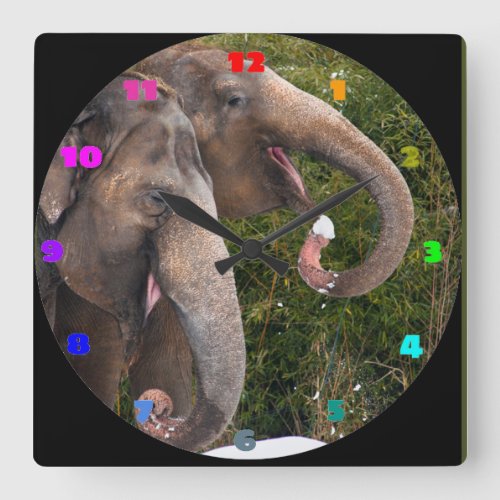 Happy smiling cute elephants playing in the snow square wall clock