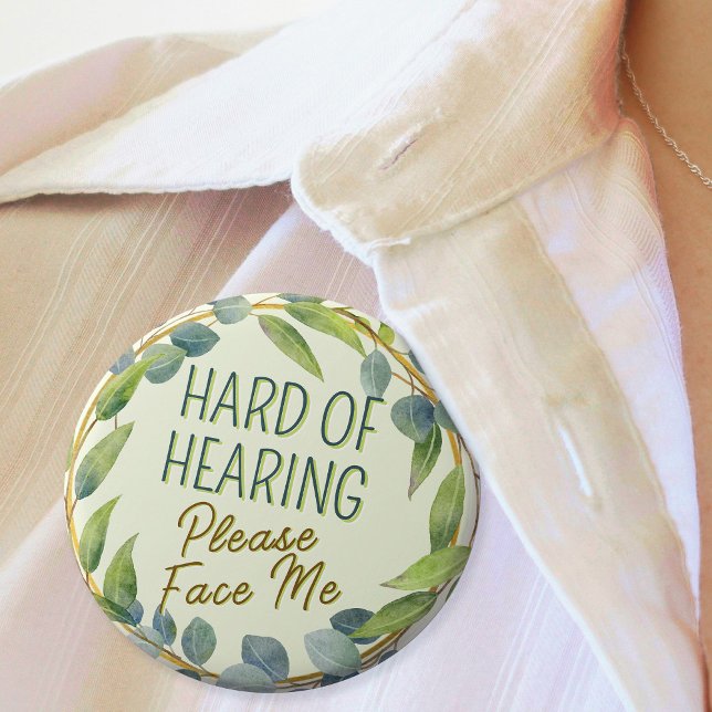 Hard of Hearing Please Face Me Green Leaves Button (In Situ. Badge with green leaves border and text "Hard of Hearing, Please Face Me")