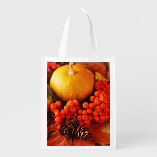 Harvested pumpkins with fall leaves reusable grocery bag