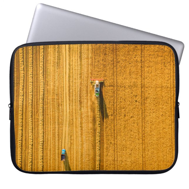 Harvester machine working in field. Combine harves Laptop Sleeve (Front)