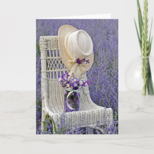 hat and purple flower bouquet on chair card