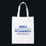 Have a Pawsitively Wonderful Hanukkah Grocery Bag<br><div class="desc">This delightful design showcases the heartfelt text "Have a pawsitively wonderful Hanukkah." The text is presented in blue and silver colors, with the letter "o" in "wonderful" playfully substituted with a paw print. This design captures the joy and celebration of Hanukkah with a pet-friendly twist. The combination of blue and...</div>