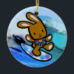 Hawaiian Surfing Bunny Holiday Cartoon Ceramic Ornament<br><div class="desc">There is nothing better than a tropical vacation during the winter holidays! And even better, our adorable surfing bunny, Coco takes on the big waves on the North Shore of Oahu, Hawaii. He brings with him the Aloha sprit for the holidays and wishes you a "Mele Kalikimaka" (Merry Christmas). This...</div>