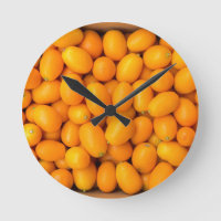 Heap of orange kumquats in cardboard box