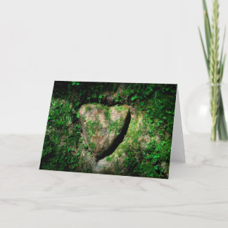 Heart ingraved in a rock holiday card