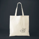 Heart Locket & Bow Illustration Custom Wedding Tote Bag<br><div class="desc">Celebrate your love story with these custom wedding totes, featuring a romantic locket and bow design. Perfect for couples who cherish sentimental touches, these totes are personalized with your initials and wedding date. The minimalist black and white style fits seamlessly into any wedding theme, whether it’s a vintage-inspired affair or...</div>