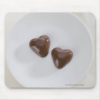 Heart shaped chocolate candies on a plate mouse pad
